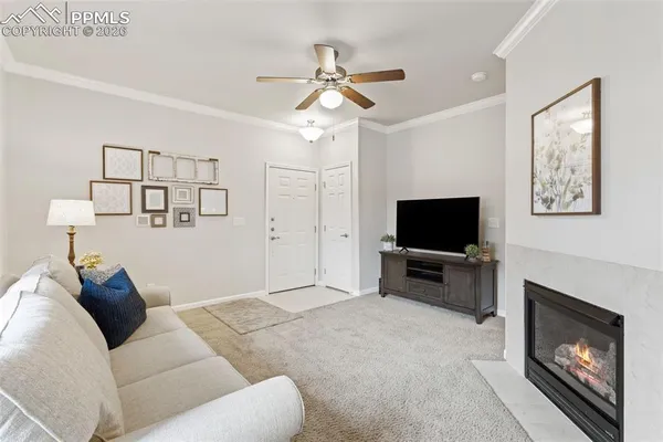 a living room with furniture a flat screen tv and a fireplace
