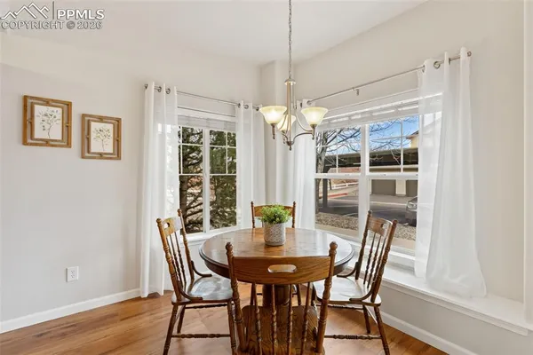 a view of a dining room with furniture window and wooden floor