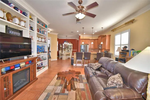 a room with furniture bookshelf and a flat screen tv