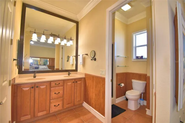 an aerial view of a house with garden space and lake view