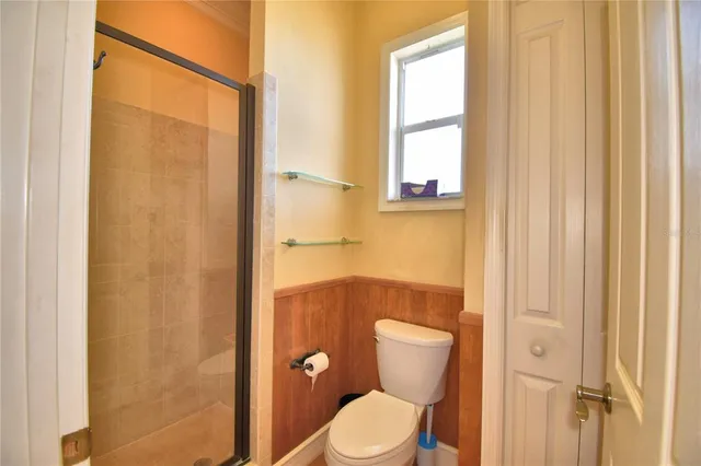 an aerial view of a house with a garden and lake view