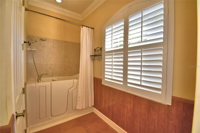 a front view of a house with a yard and potted plants