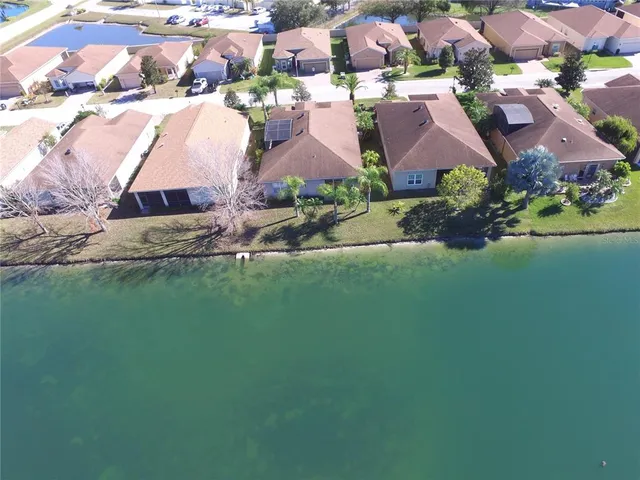 a view of a park with large trees and a wooden fence