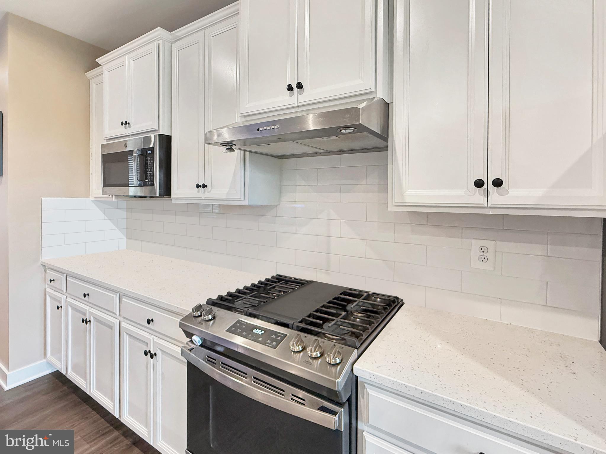 7820 Mine Run Road Hanover, MD 21076 - Photo 15 of 31 a kitchen with granite countertop white cabinets and stainless steel appliances