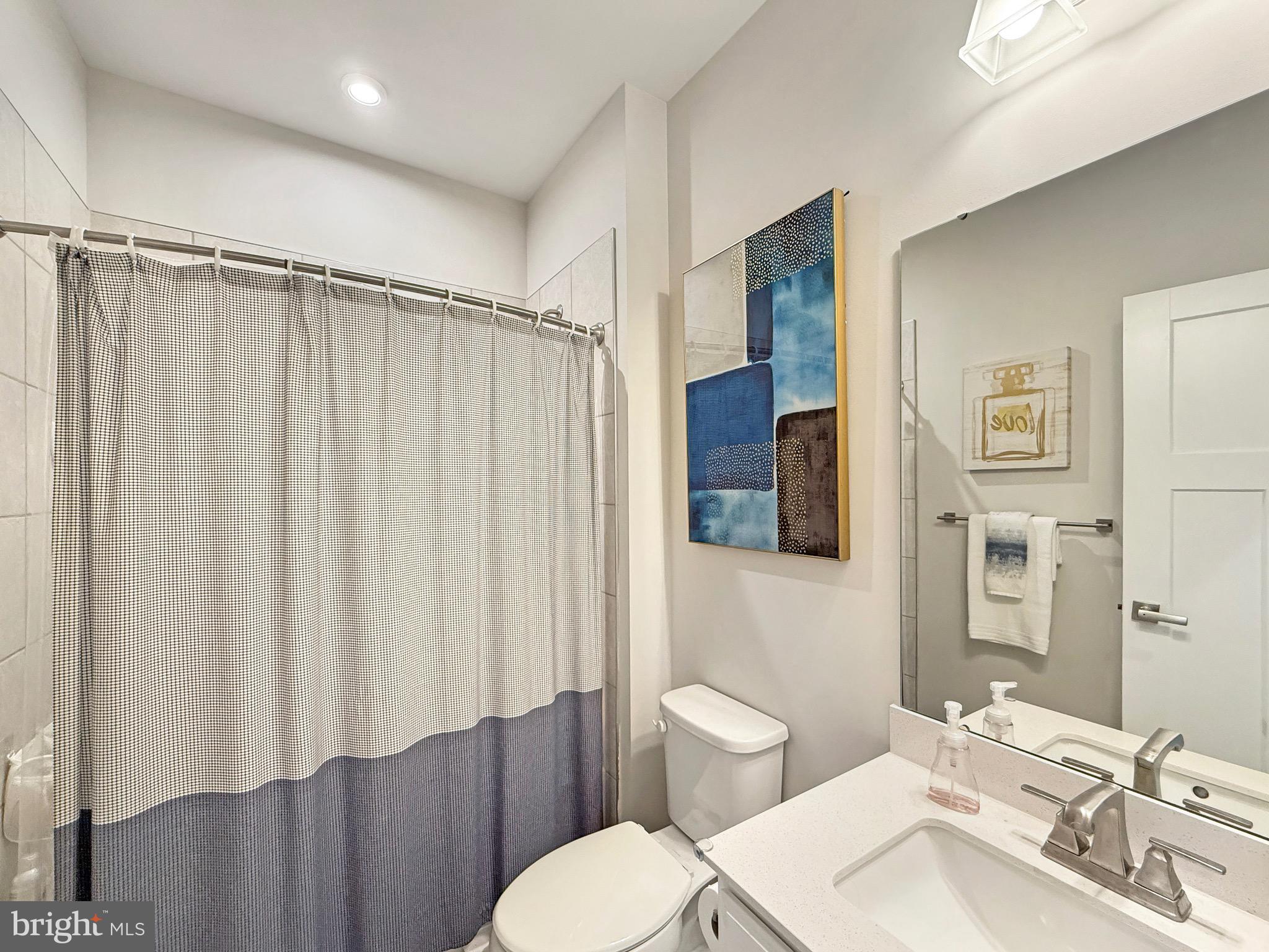 7820 Mine Run Road Hanover, MD 21076 - Photo 27 of 31 a bathroom with a sink mirror vanity and toilet
