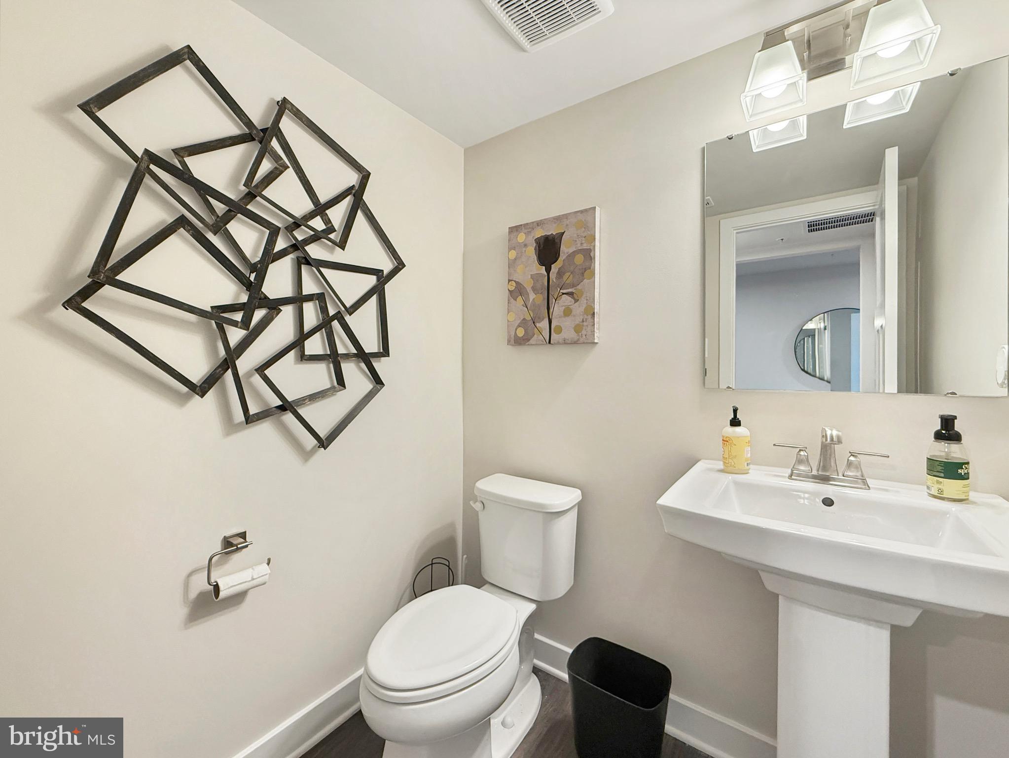 7820 Mine Run Road Hanover, MD 21076 - Photo 8 of 31 a bathroom with a toilet sink and mirror