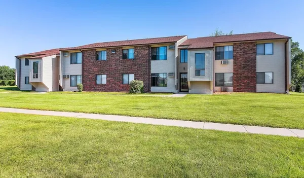 a view of a brick house with a big yard