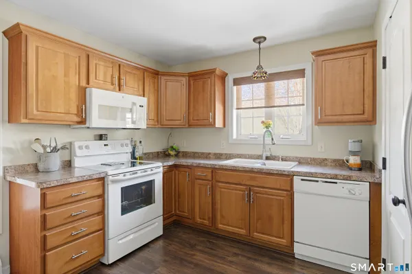 a kitchen with a stove sink and cabinets