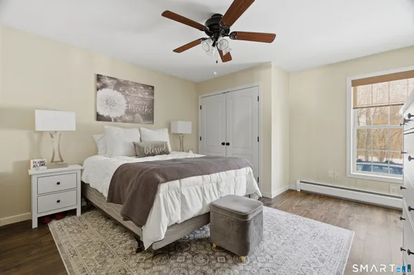 a bedroom with a large bed and a window