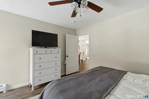 a bedroom with a bed and flat screen tv