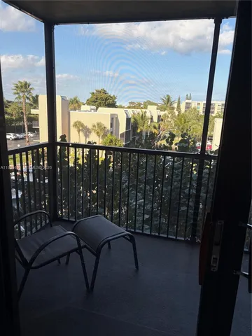 a view of a balcony with furniture
