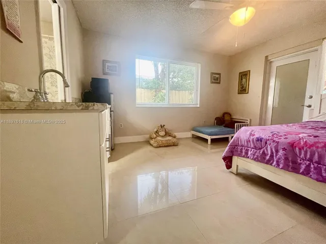 a bedroom with bed and window