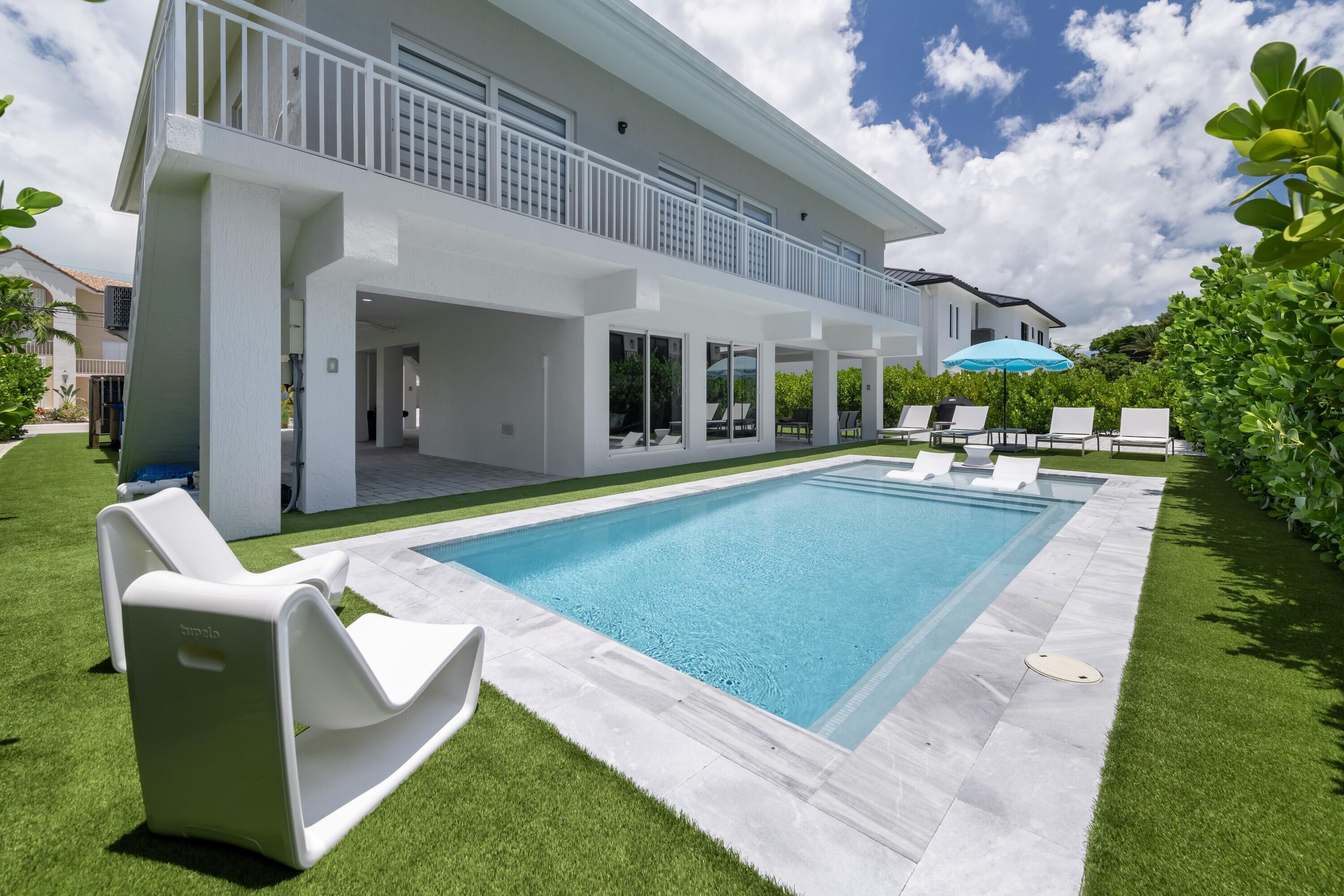 a swimming pool with outdoor seating and yard