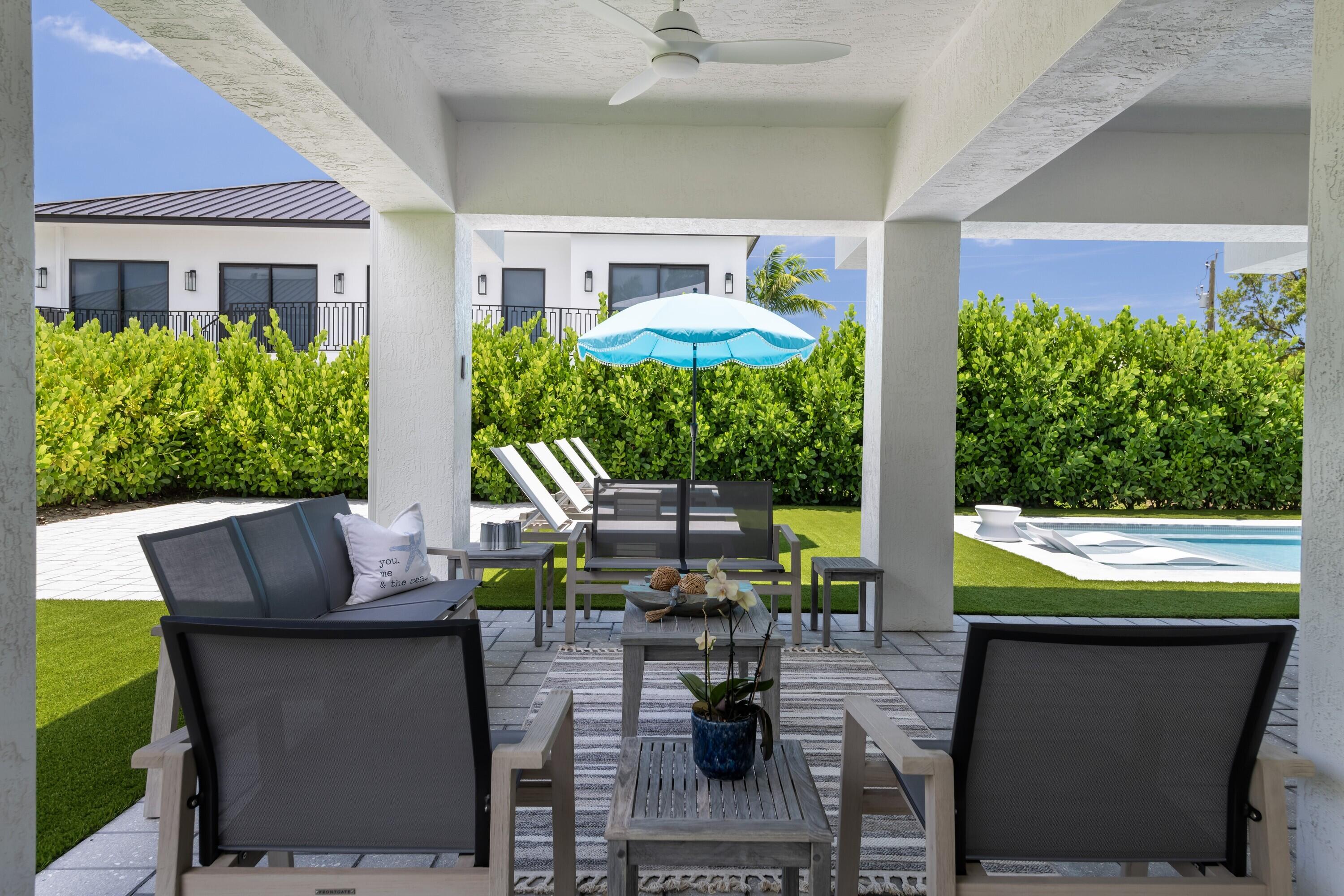 227 Corsair Road Marathon, FL 33050 - Photo 16 of 66 a view of a patio with table and chairs potted plants