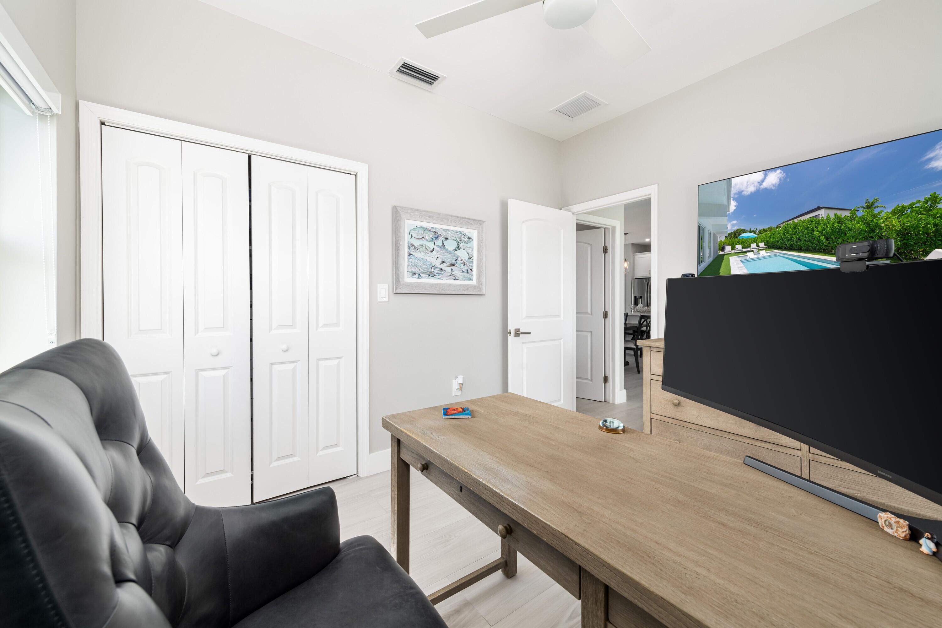 227 Corsair Road Marathon, FL 33050 - Photo 29 of 66 a view of a workspace with furniture and a potted plant