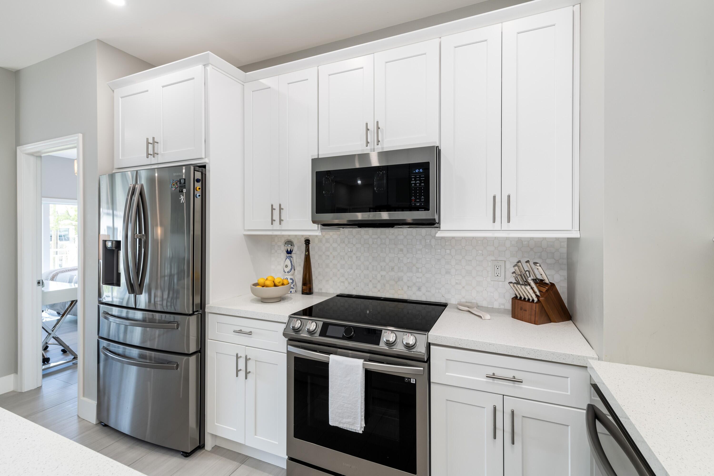 227 Corsair Road Marathon, FL 33050 - Photo 36 of 66 a kitchen with stainless steel appliances a refrigerator stove and microwave