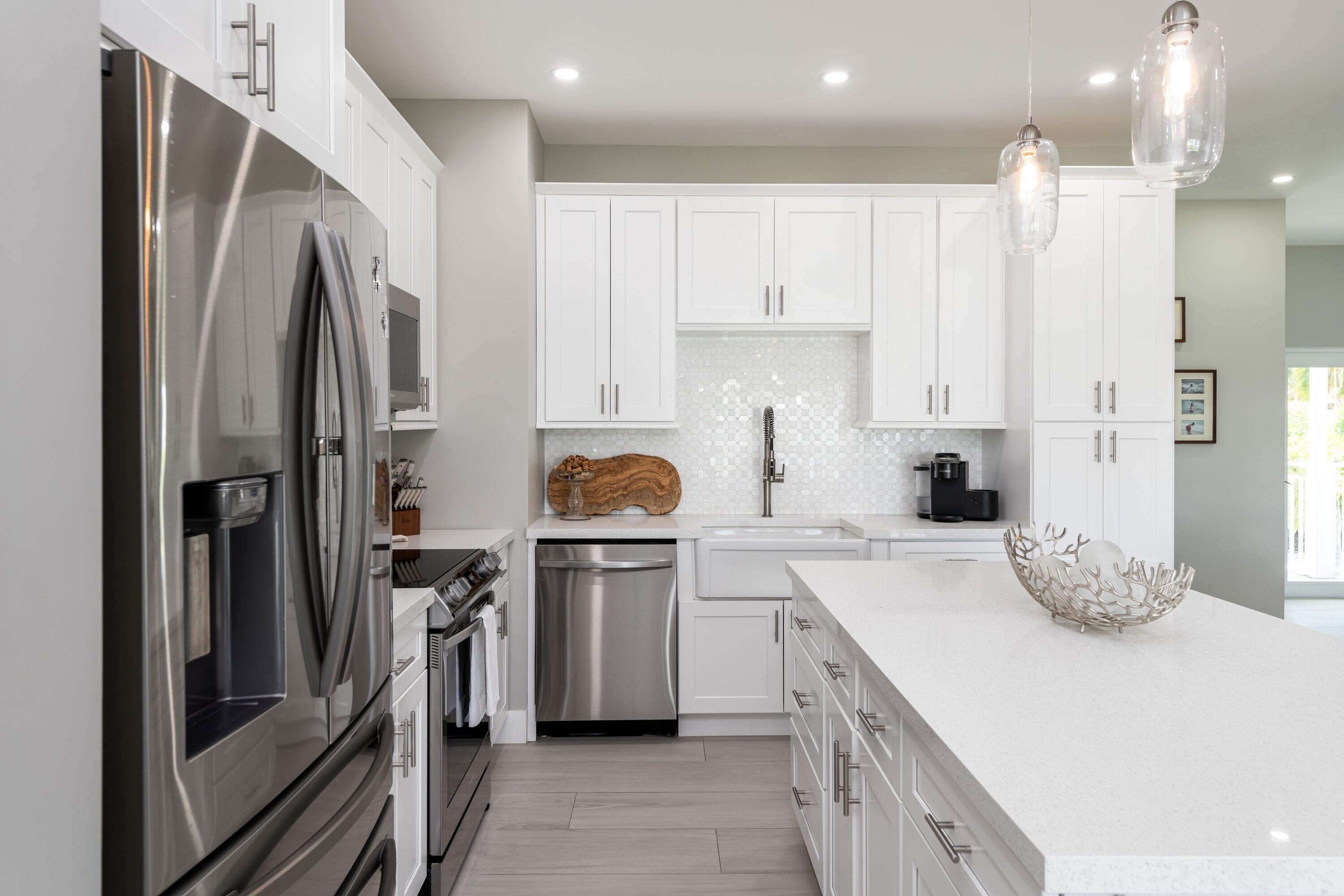 227 Corsair Road Marathon, FL 33050 - Photo 37 of 66 a kitchen with stainless steel appliances a refrigerator sink and stove