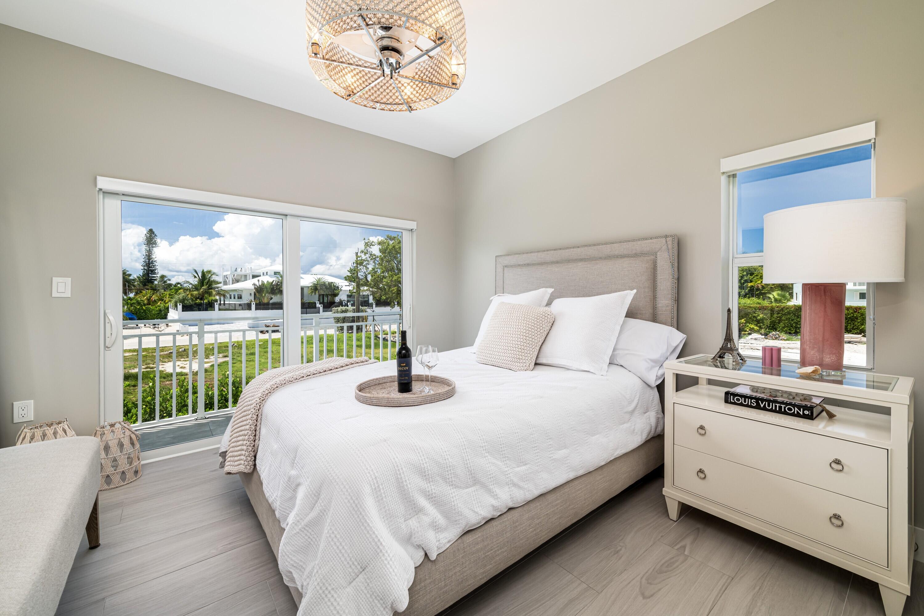 227 Corsair Road Marathon, FL 33050 - Photo 38 of 66 a large bed sitting in a bedroom next to a window