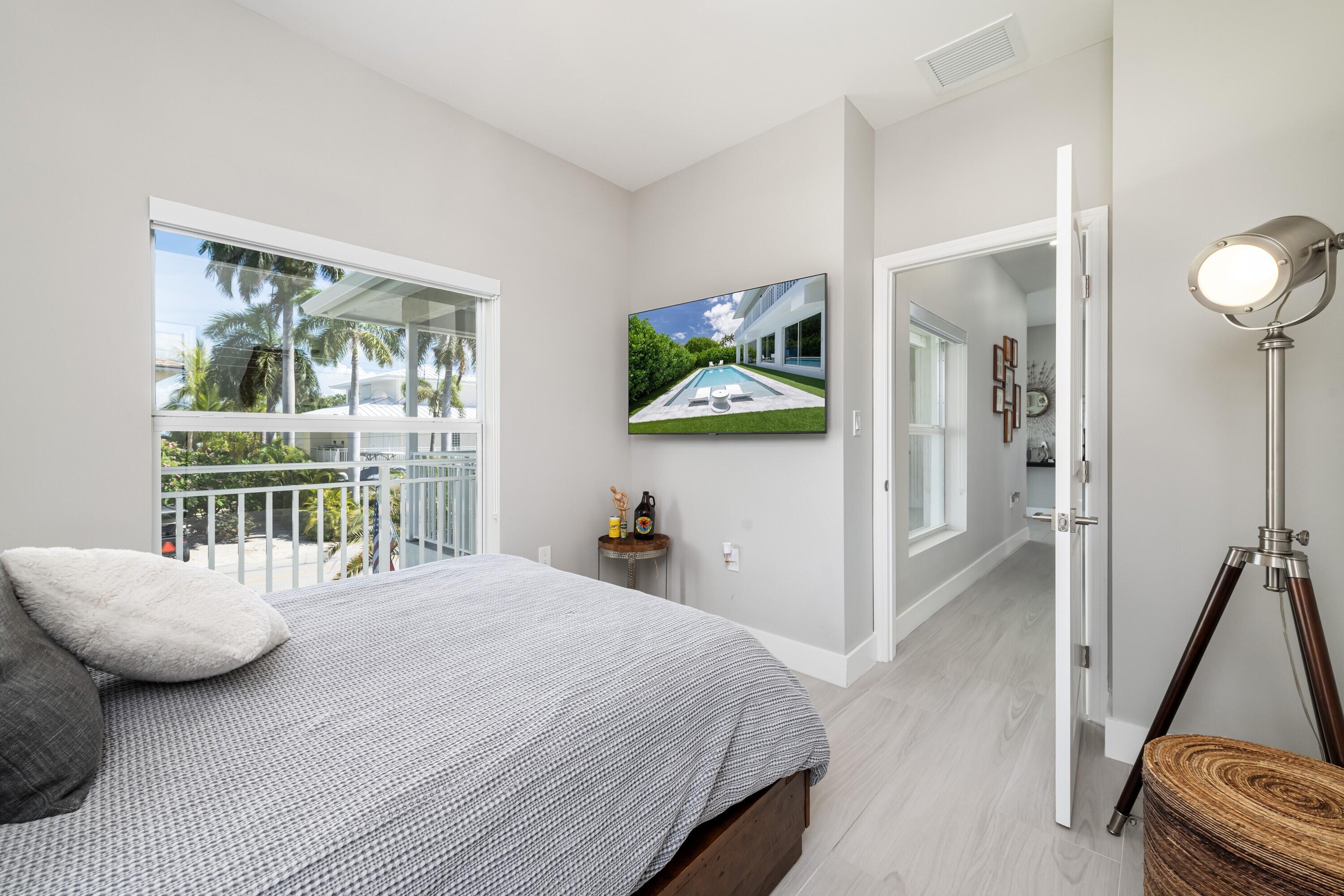227 Corsair Road Marathon, FL 33050 - Photo 40 of 66 a bedroom with a bed and a window