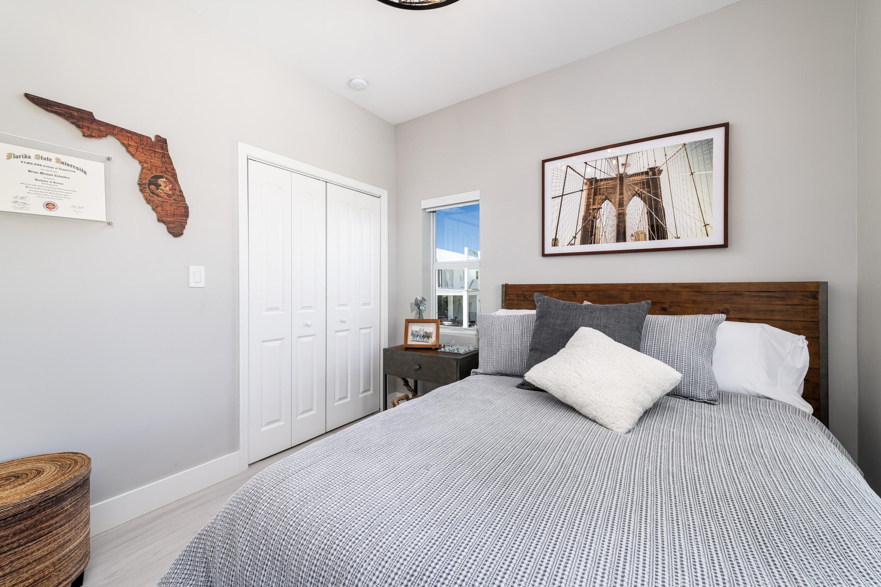 227 Corsair Road Marathon, FL 33050 - Photo 41 of 66 a bedroom with a bed and a painting on the wall