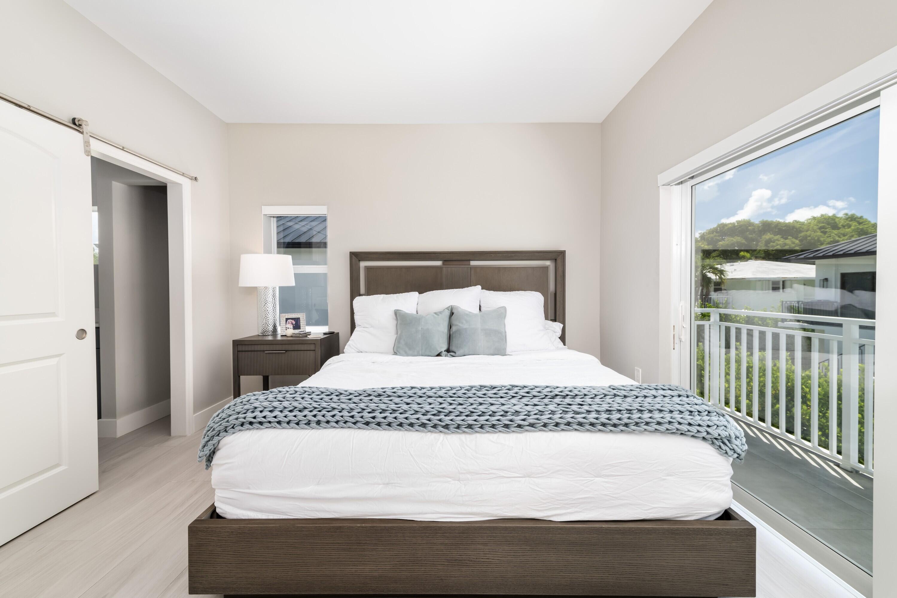 227 Corsair Road Marathon, FL 33050 - Photo 43 of 66 a large bed sitting in a bedroom next to a window