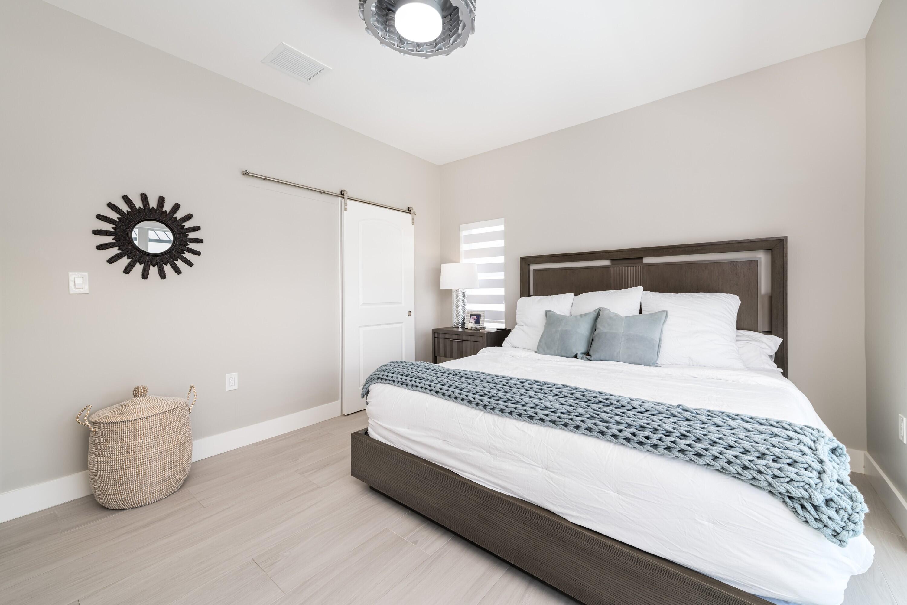 227 Corsair Road Marathon, FL 33050 - Photo 44 of 66 a bedroom with a bed and a potted plant