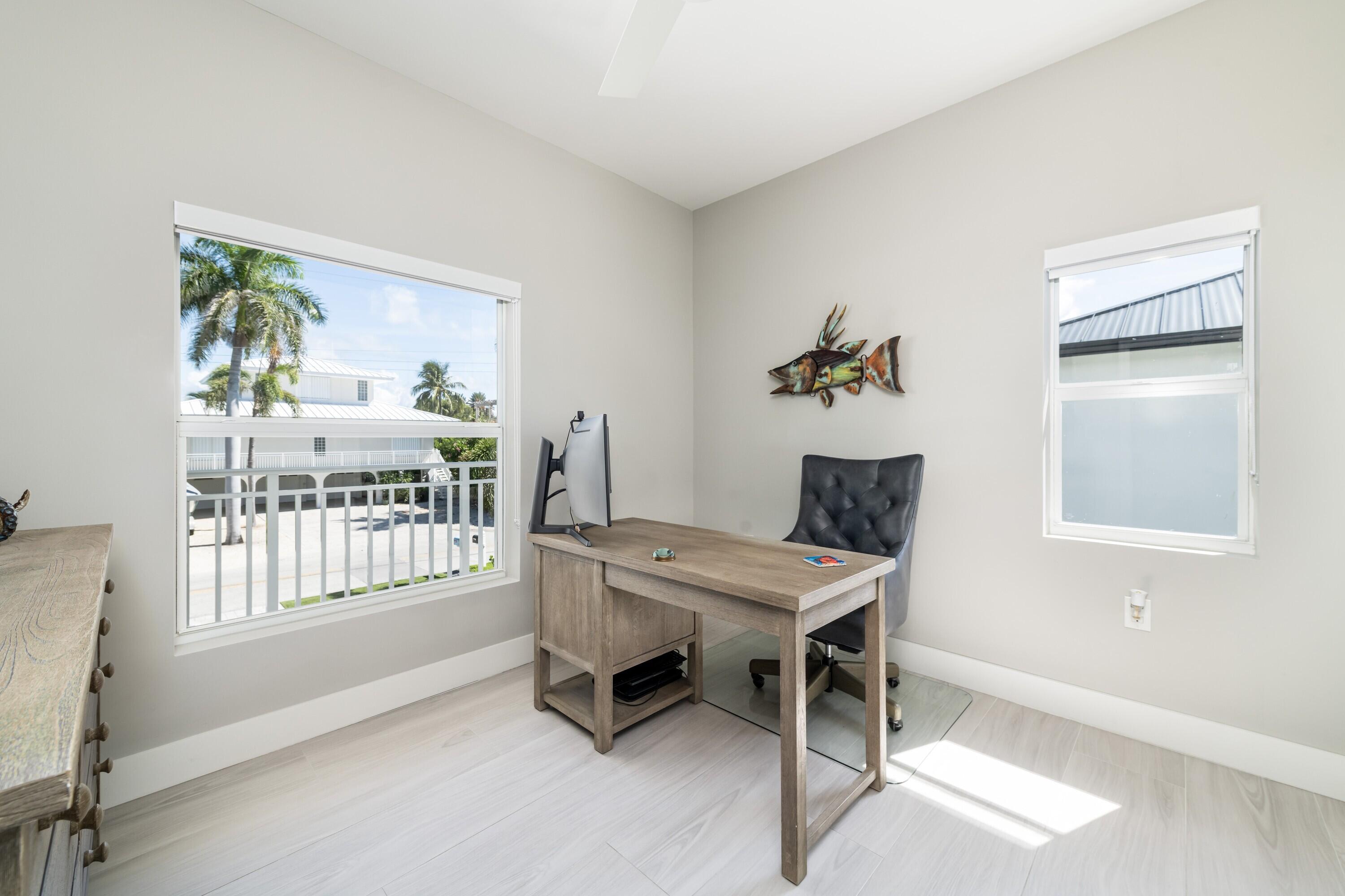 227 Corsair Road Marathon, FL 33050 - Photo 47 of 66 a workspace with furniture and a window