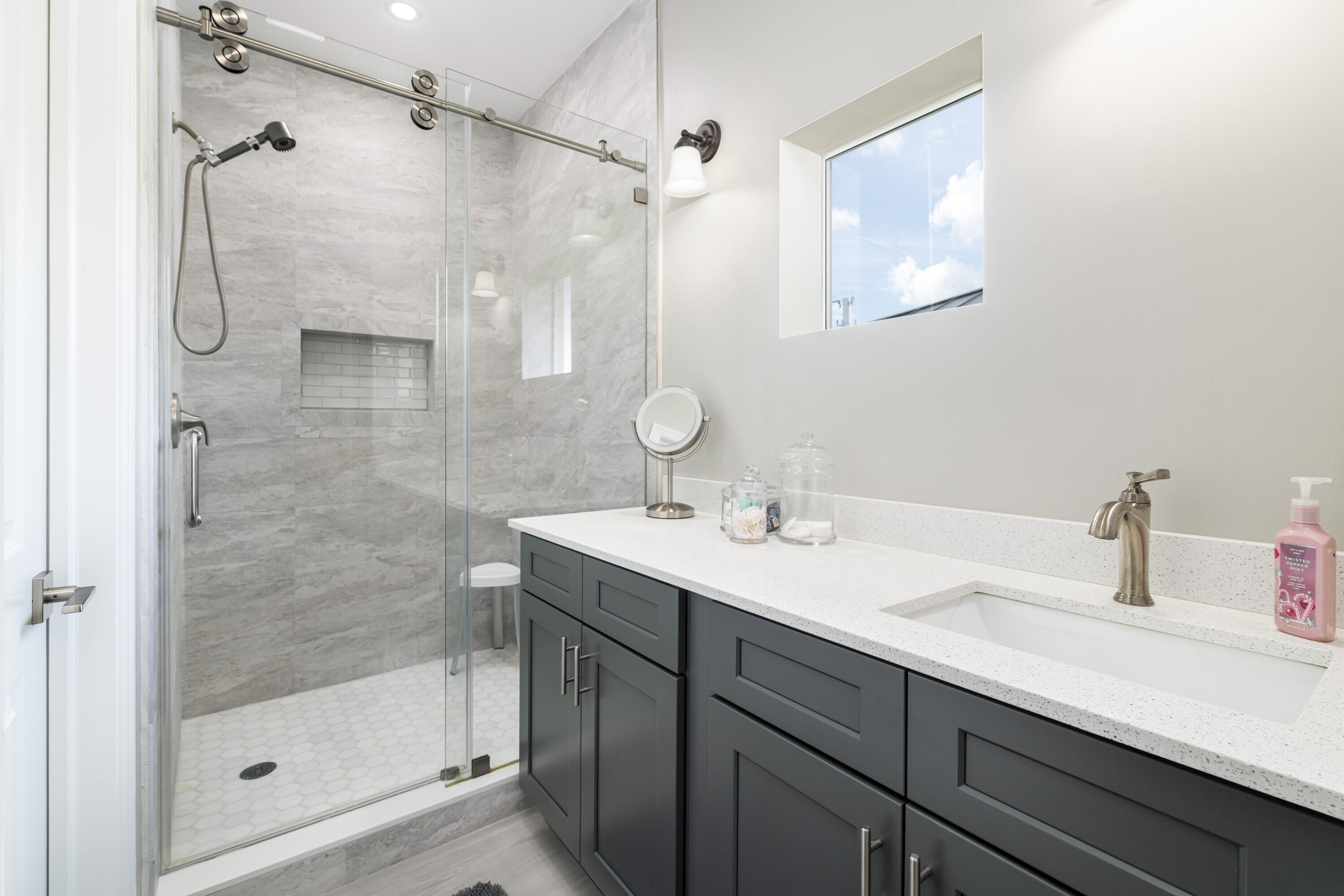 227 Corsair Road Marathon, FL 33050 - Photo 48 of 66 a bathroom with a shower sink and mirror