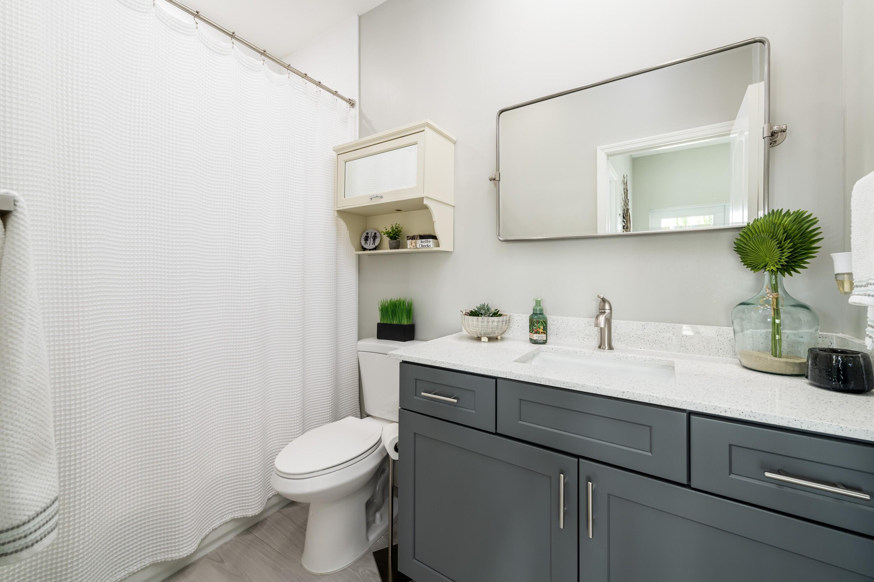 227 Corsair Road Marathon, FL 33050 - Photo 49 of 66 a bathroom with a toilet a sink and mirror