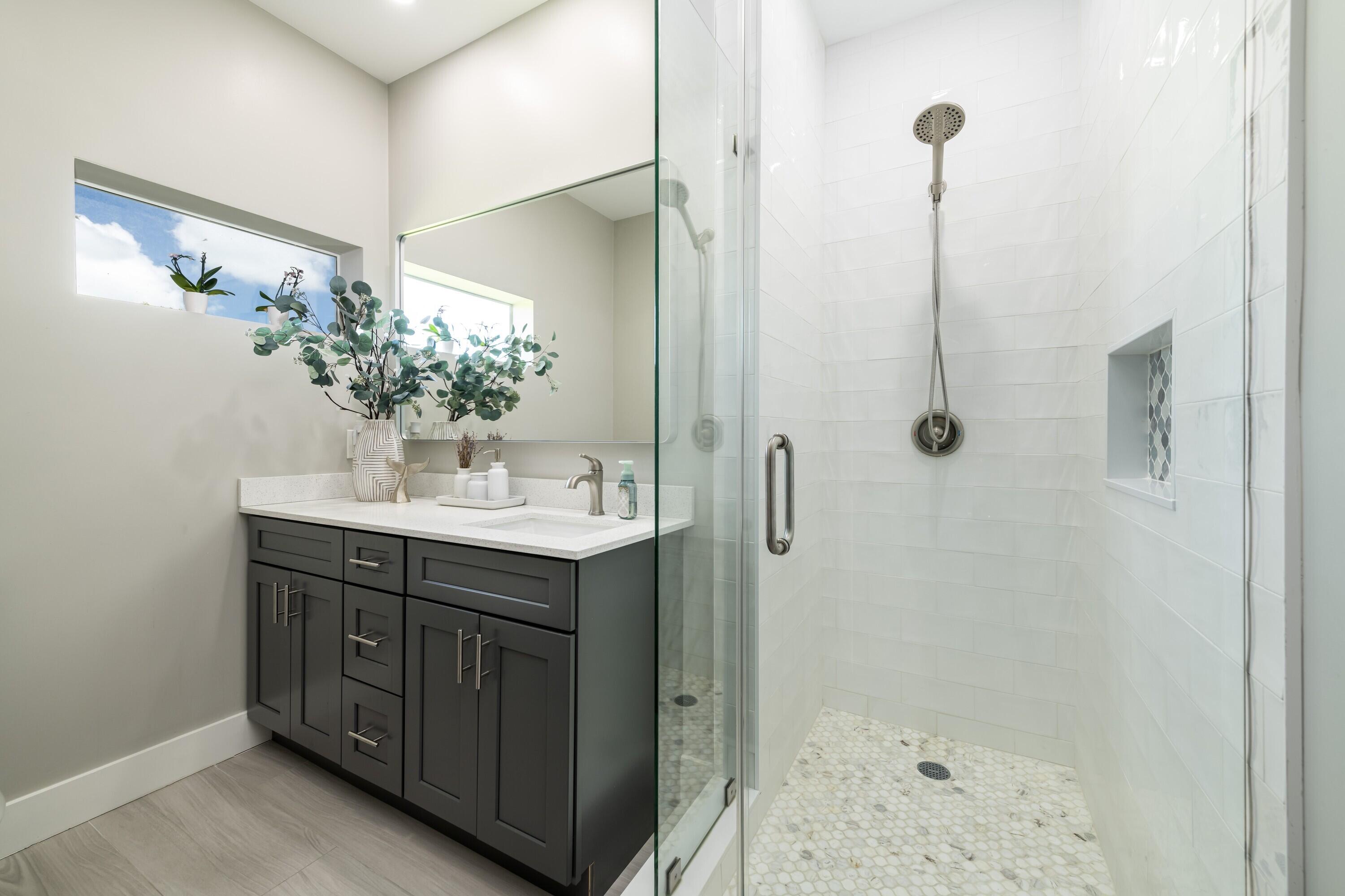 227 Corsair Road Marathon, FL 33050 - Photo 50 of 66 a bathroom with a shower sink and mirror