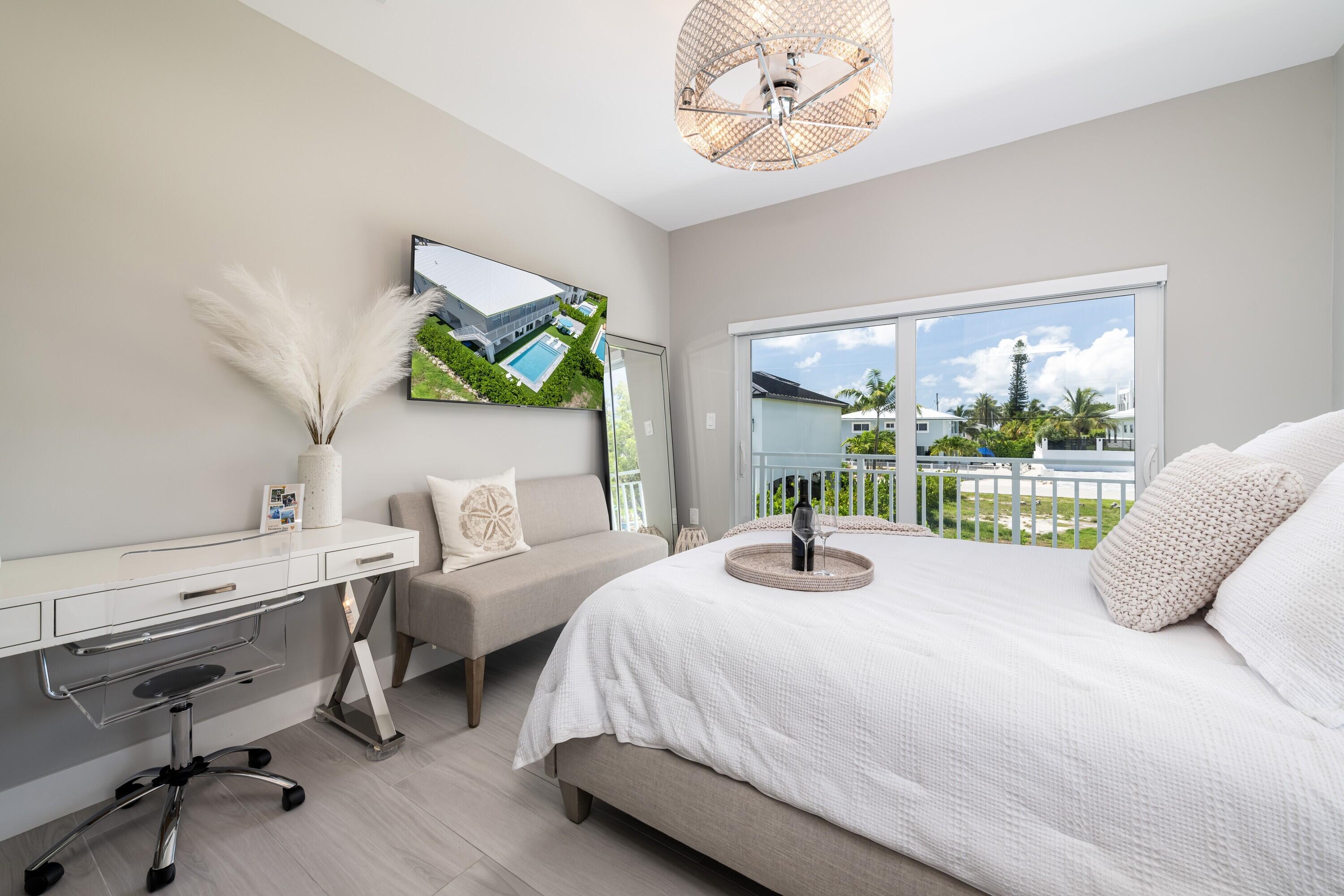 227 Corsair Road Marathon, FL 33050 - Photo 5 of 66 a bedroom with a bed and a large window