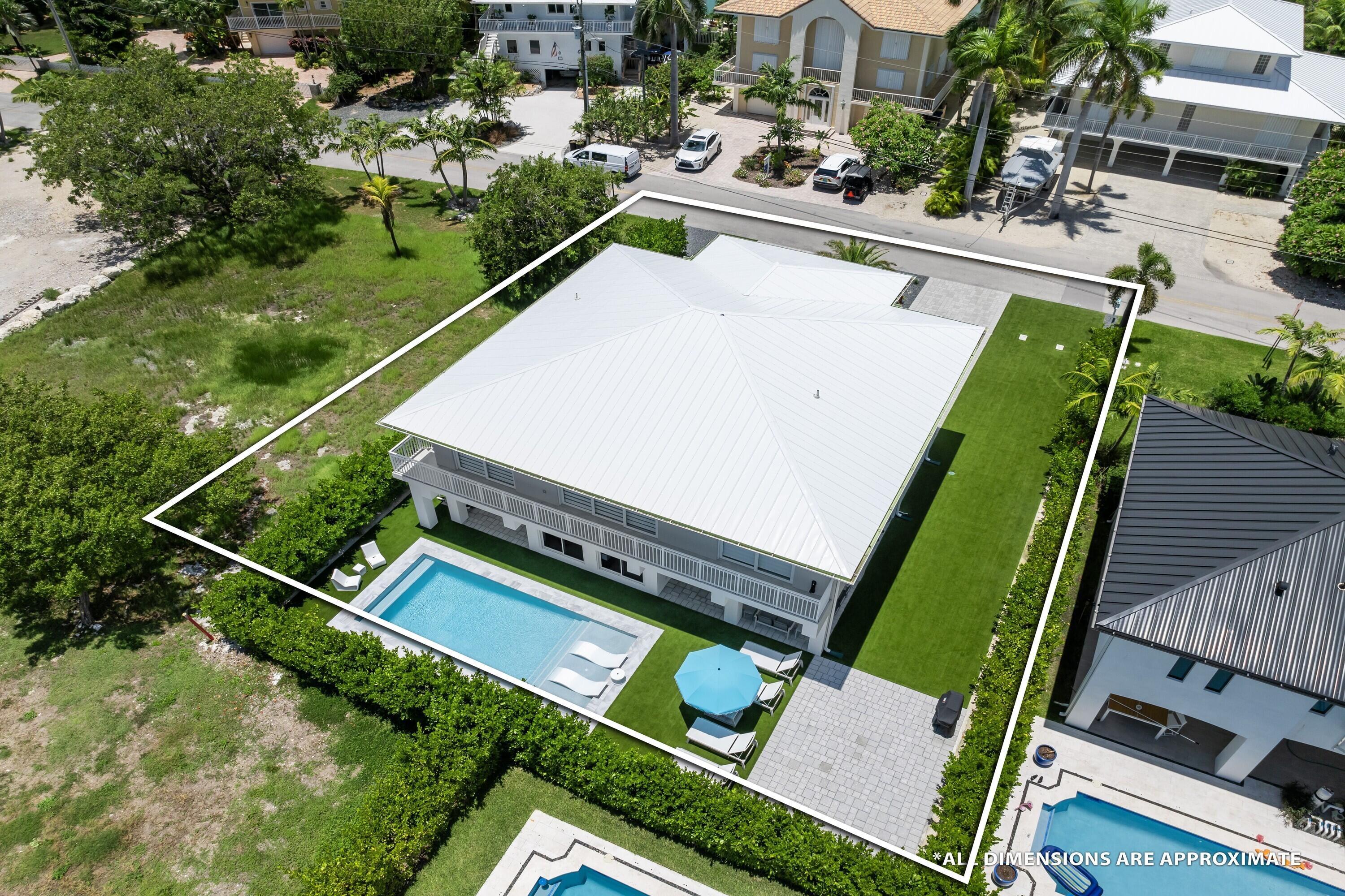 227 Corsair Road Marathon, FL 33050 - Photo 60 of 66 an aerial view of a tennis ground with a white house