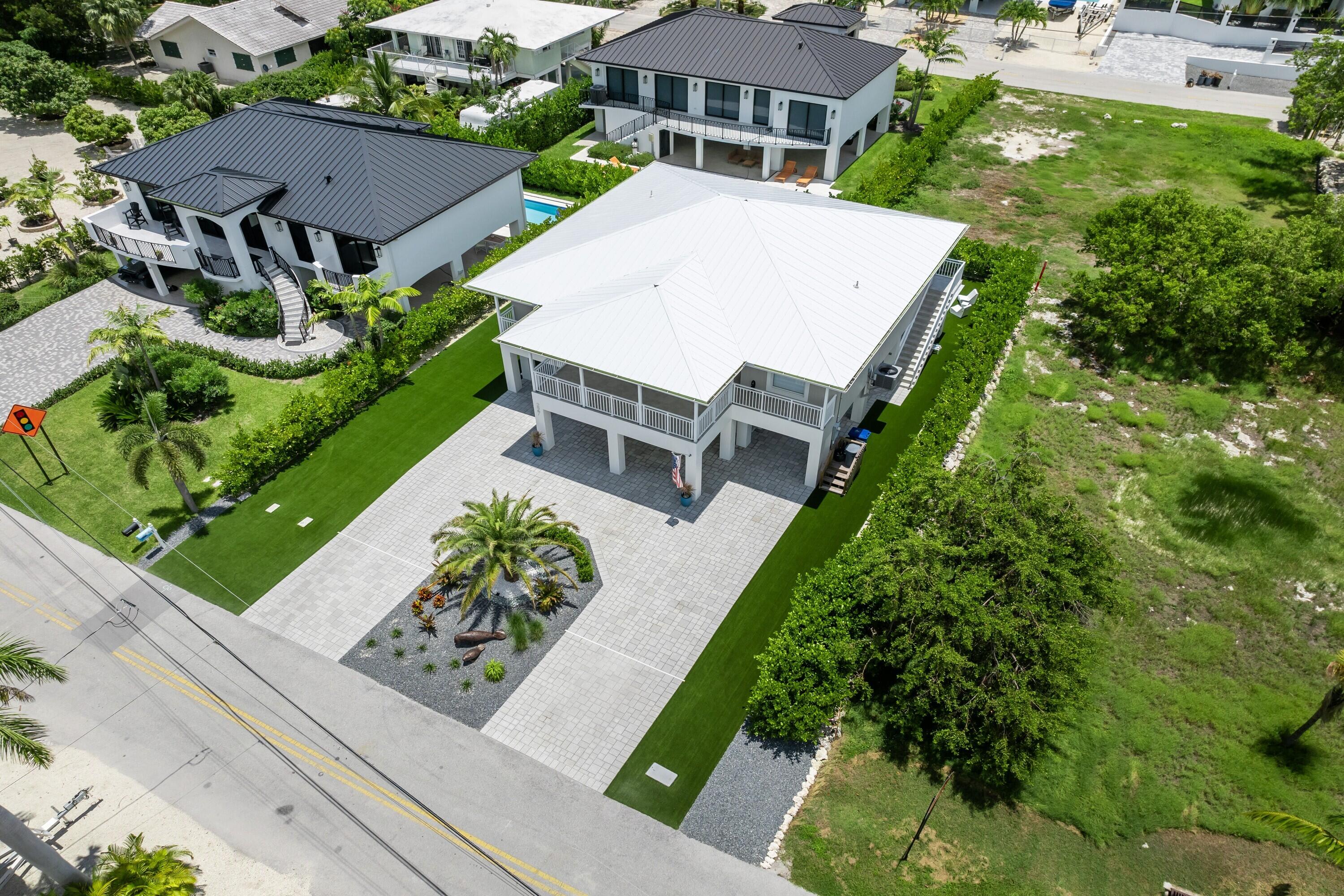 227 Corsair Road Marathon, FL 33050 - Photo 9 of 66 an aerial view of a house with a yard and potted plants