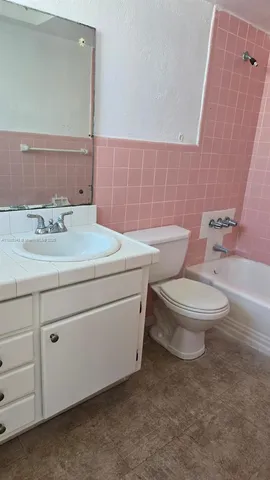 a bathroom with a sink toilet and vanity
