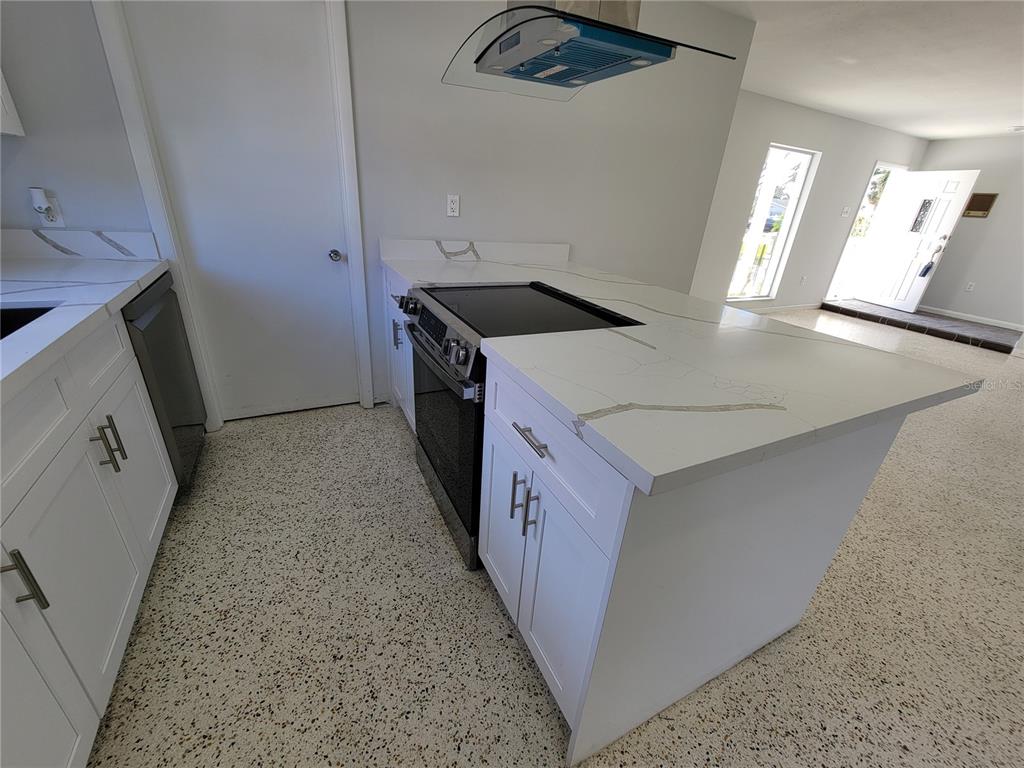 1732 Boca Raton Court Punta Gorda, FL 33950 - Photo 32 of 64 a kitchen with granite countertop a sink stove and refrigerator