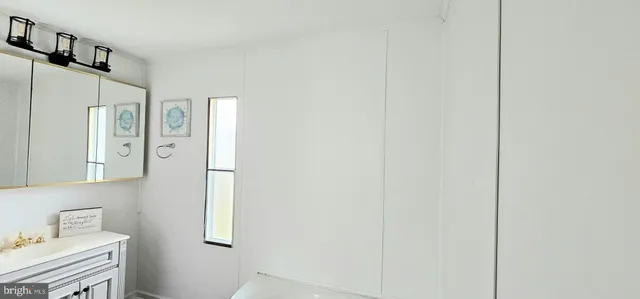 a bathroom with a shower sink and mirror