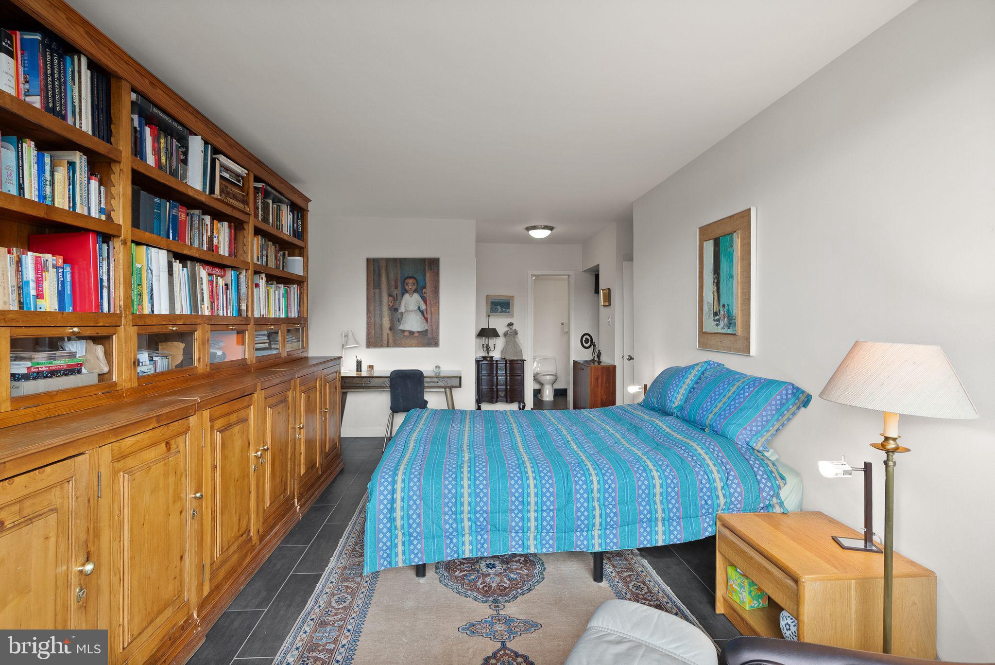 400 Madison Street, Unit 409 Alexandria, VA 22314 - Photo 27 of 98 a living room with furniture and a book shelf