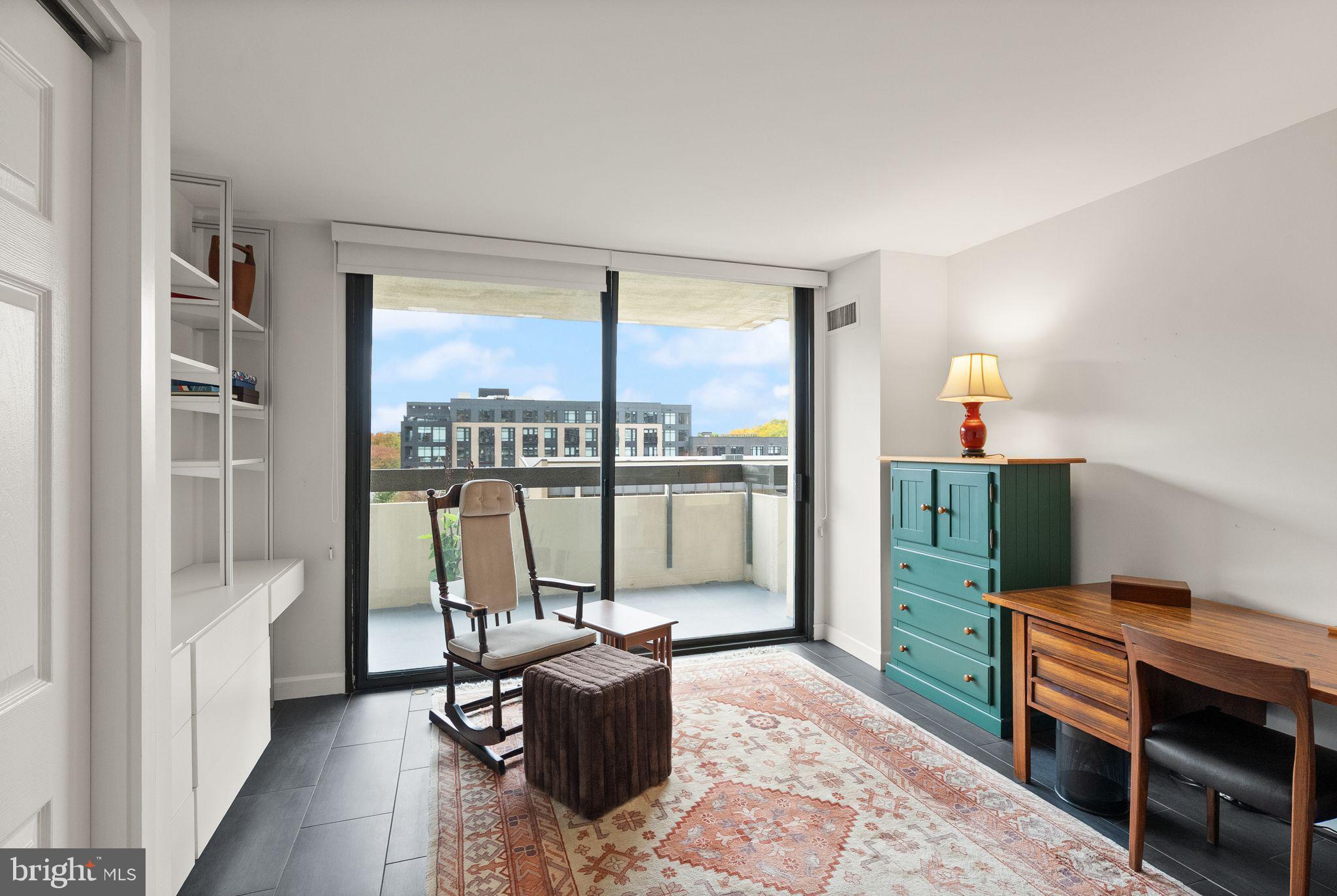 400 Madison Street, Unit 409 Alexandria, VA 22314 - Photo 32 of 98 a living room with furniture a large window and wooden floor