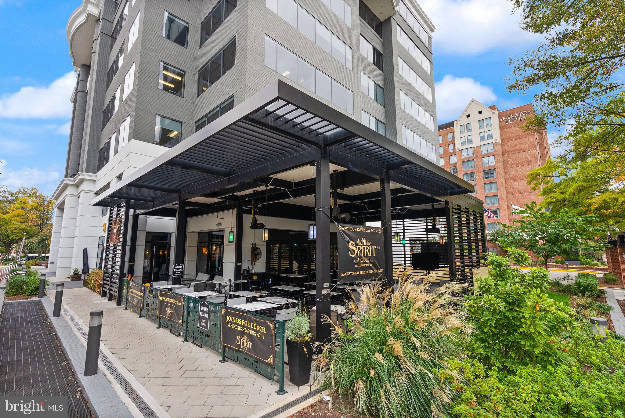 400 Madison Street, Unit 409 Alexandria, VA 22314 - Photo 91 of 98 a view of a patio with table and chairs and potted plants