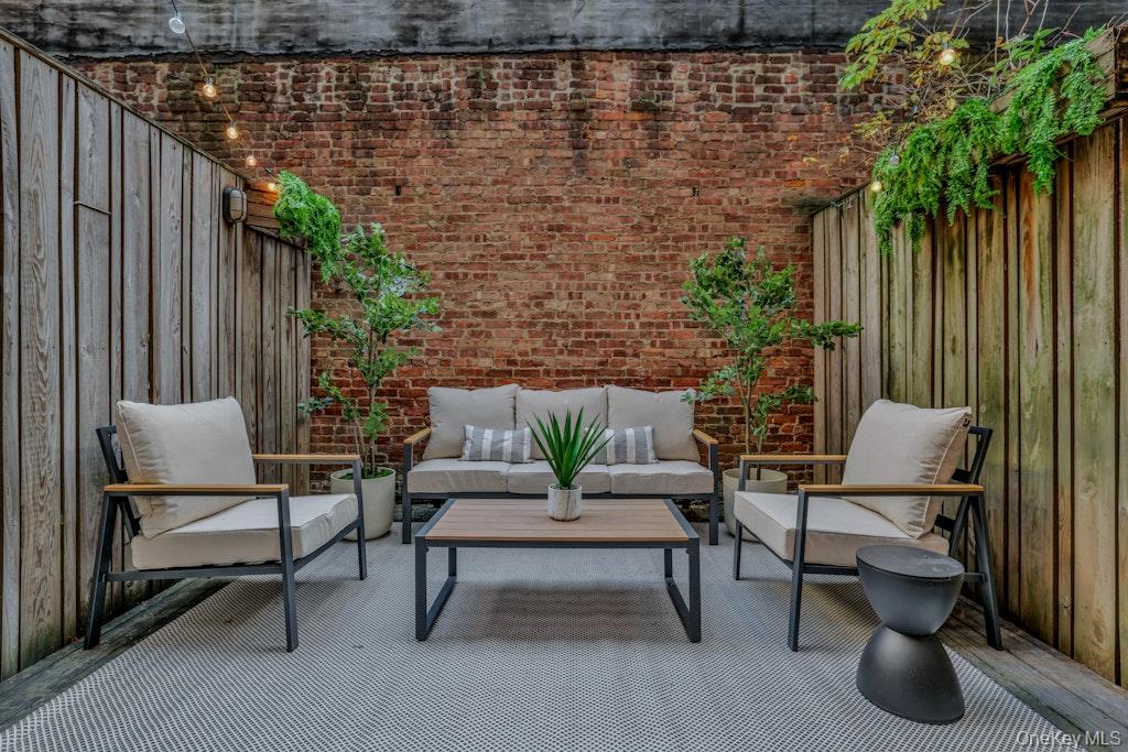 155 West 15th Street, Unit 1E Manhattan, NY 10011 - Photo 25 of 29 a balcony with chairs and a potted plant