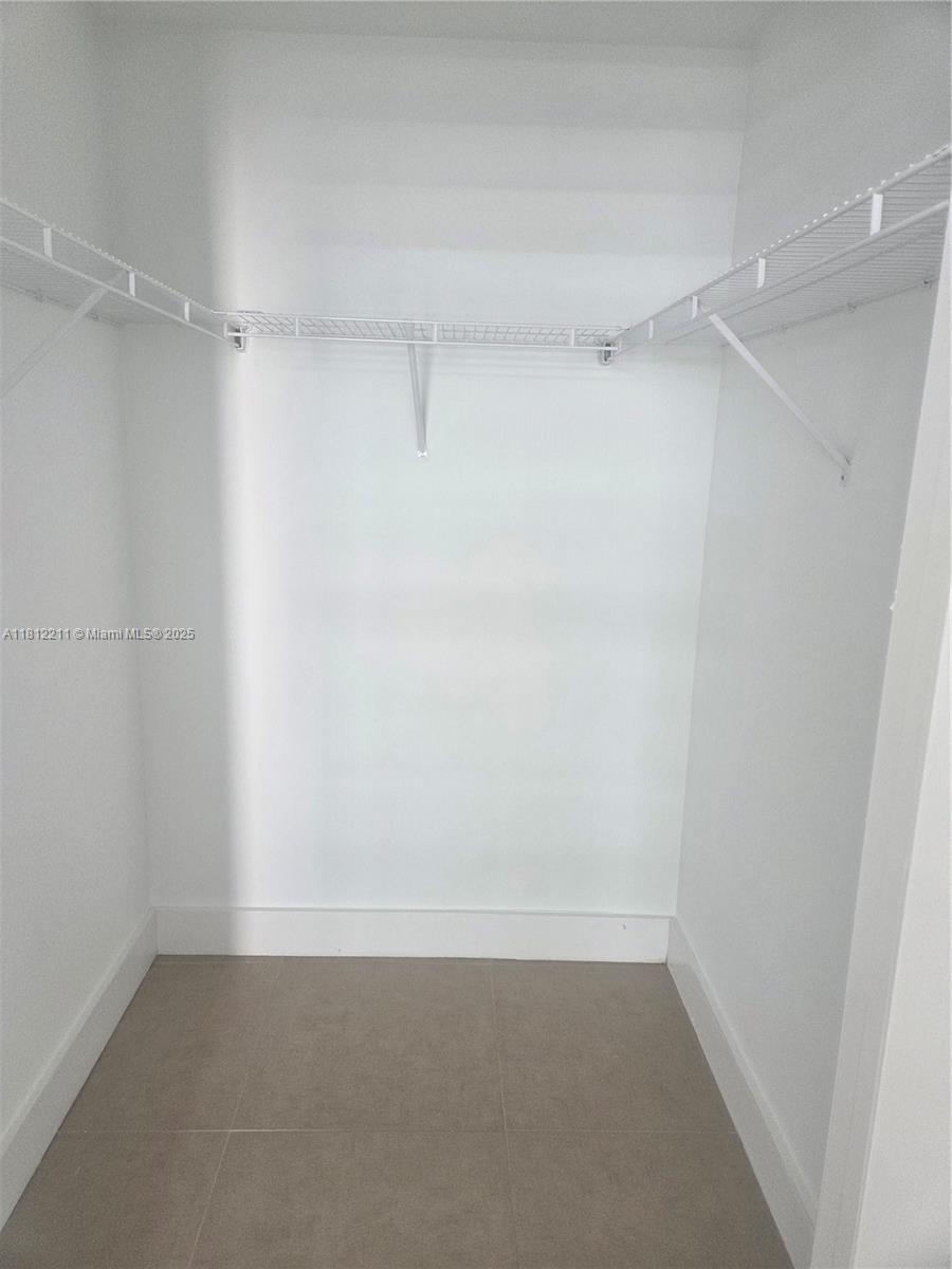 79 Southwest 12th Street, Unit 2409 Miami, FL 33130 - Photo 11 of 13 a view of an empty walk in closet