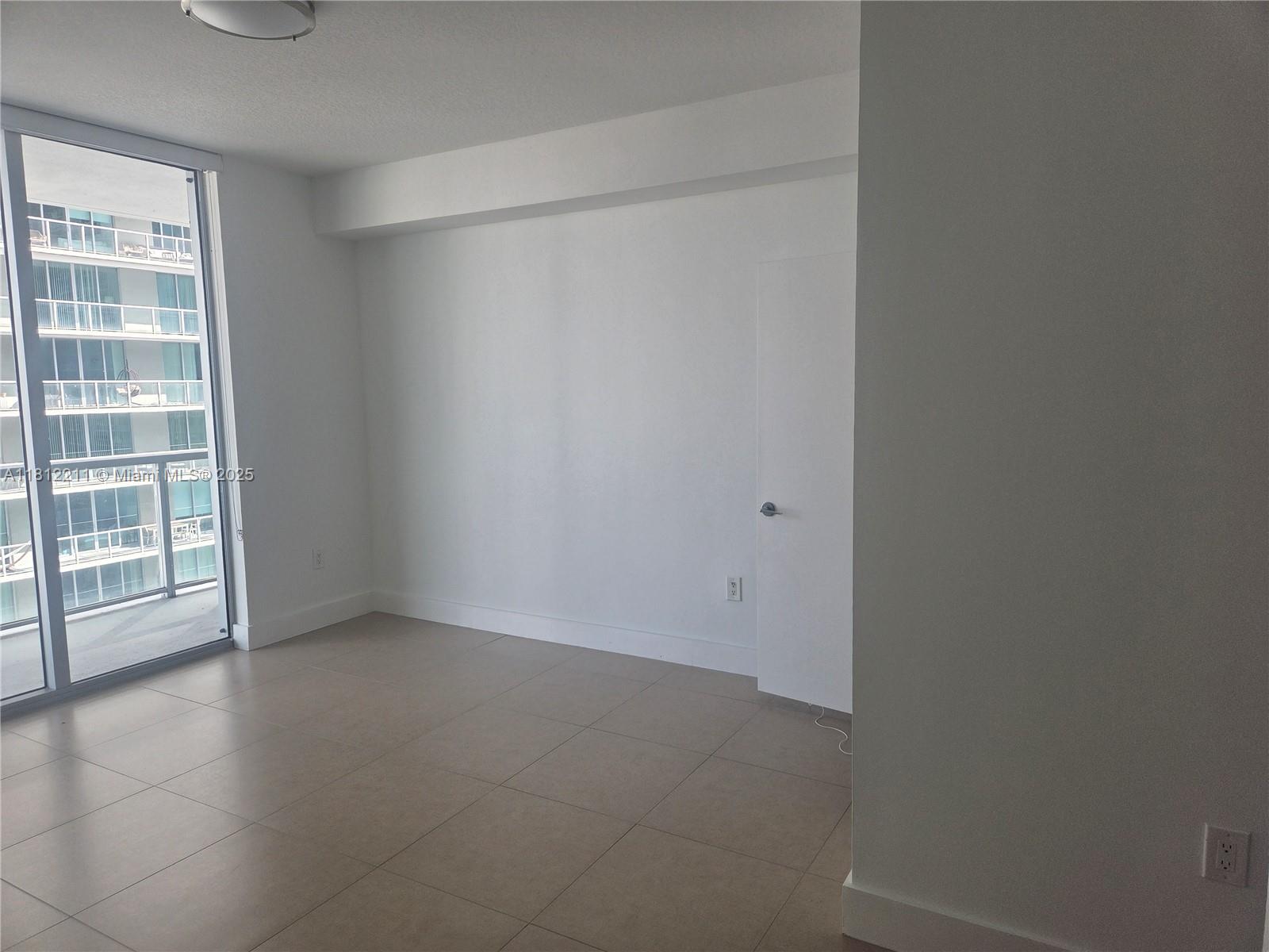 79 Southwest 12th Street, Unit 2409 Miami, FL 33130 - Photo 6 of 13 an empty room with windows