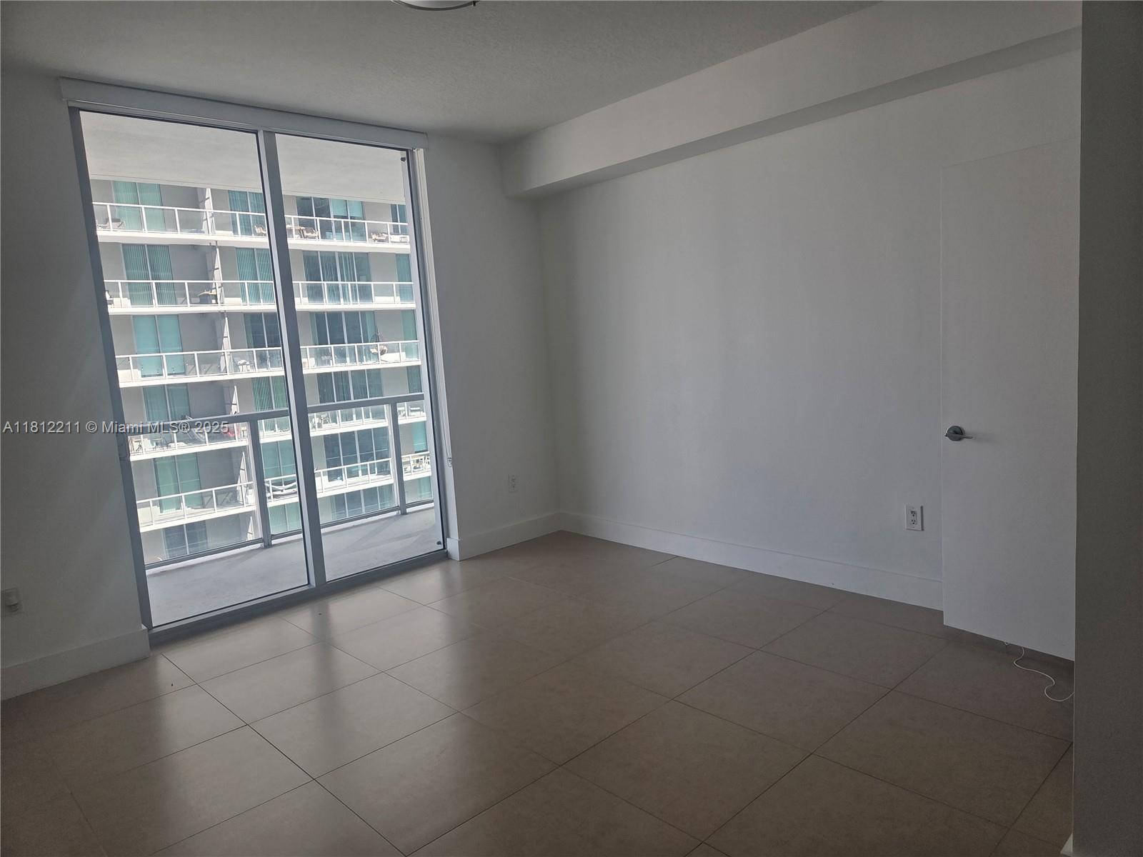 79 Southwest 12th Street, Unit 2409 Miami, FL 33130 - Photo 7 of 13 an empty room with a empty space and a window