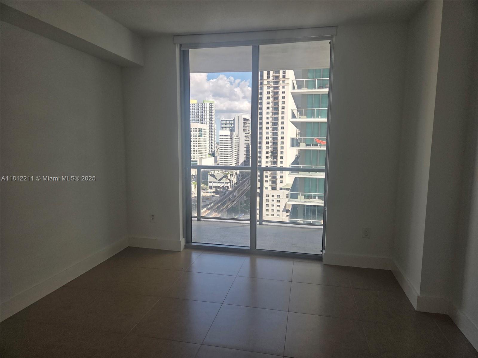 79 Southwest 12th Street, Unit 2409 Miami, FL 33130 - Photo 10 of 13 a view of an empty room with a window