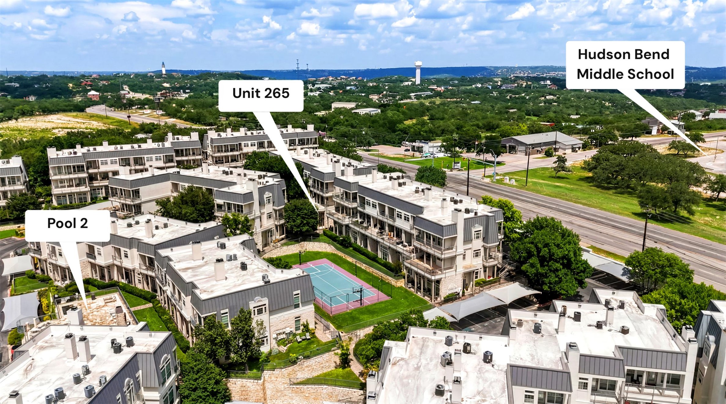2918 Ranch Road 620, Unit 265 Austin, TX 78734 - Photo 40 of 40 An aerial perspective showcases a vibrant community with an outdoor court, inviting swimming pool, and verdant landscapes.