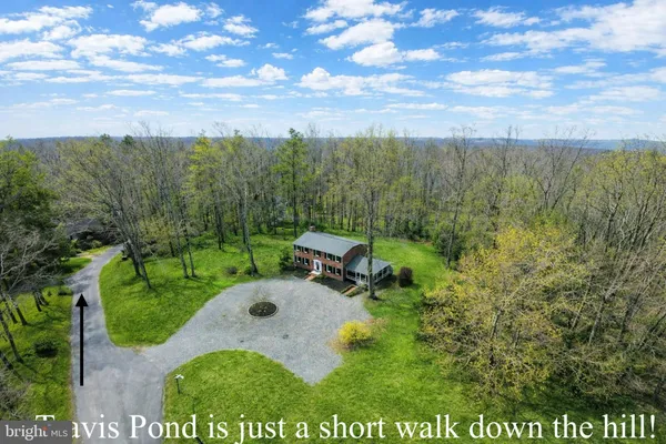 a kitchen with stainless steel appliances granite countertop a sink a stove a refrigerator cabinets a dining table and chairs