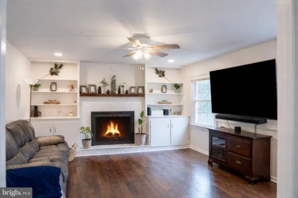 a bedroom with a bed and a flat tv screen on dresser