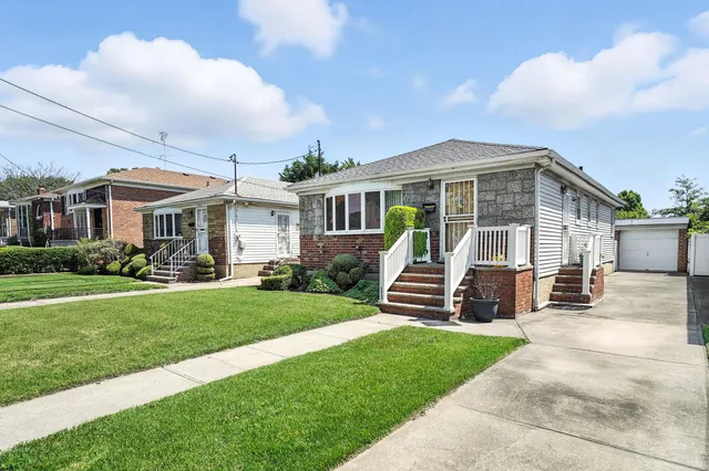 a front view of a house with a garden