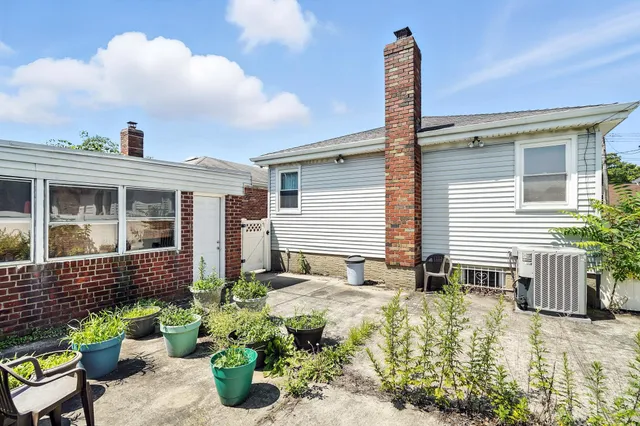 a front view of a house with potted plants