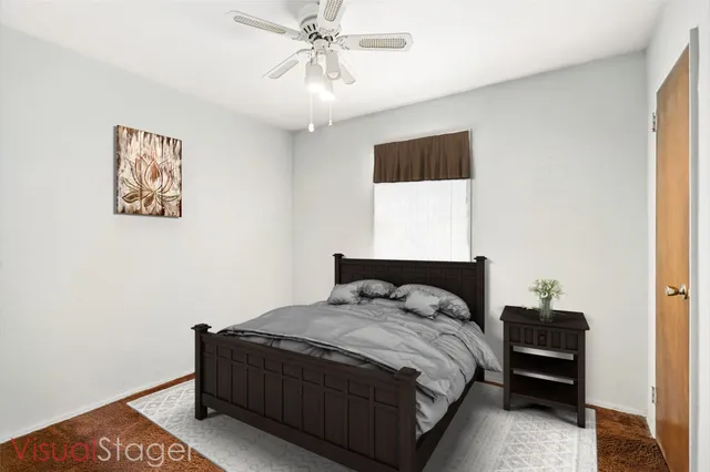 a bedroom with a bed and a painting on the wall